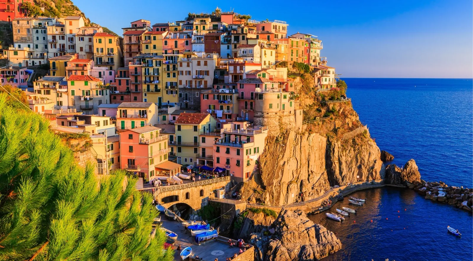 Cinque Terre from Florence — Manarola at golden hour with cliffside pastel houses above a turquoise harbour