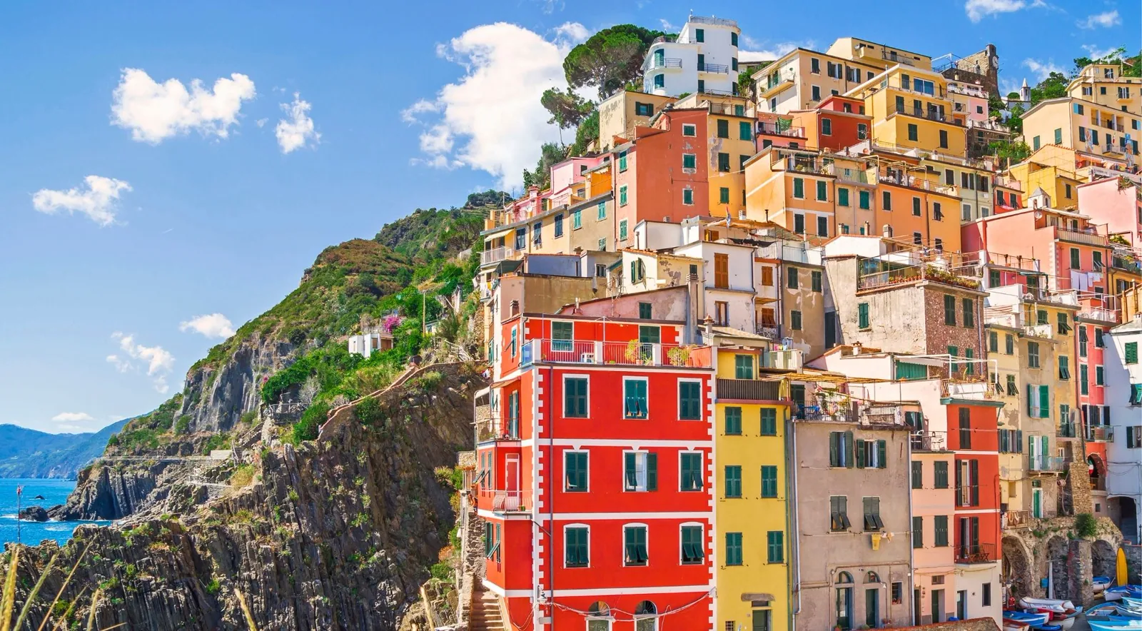 Riomaggiore, Cinque Terre — pastel tower houses stacked down a steep ravine above the harbour